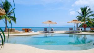 a swimming pool with chairs and umbrellas on the beach at Azul Beach Resort in Bophut +42 photos
