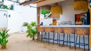 a bar with wooden stools in a beach house at Azul Beach Resort in Bophut