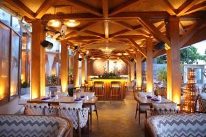 a restaurant with tables and chairs and a bar at Radisson Blu Resort Galle in Galle