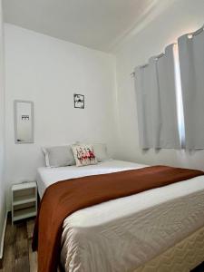 a bedroom with a large bed in a room at A Casa di Minas in Três Corações