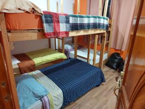 a room with two bunk beds and a bed at Las Armonías Hostal in Panajachel