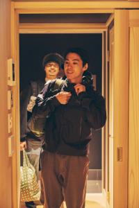 two men standing in front of a door at GEOSPOT Motohakone C 2026年1月 New Open in Hakone