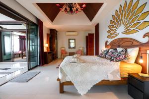 a bedroom with a bed and a dining room at 6 Bedrooms Seaview With Pool - Belle Sunset Villa in Ko Lanta