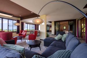 a living room with blue couches and red chairs at 6 Bedrooms Seaview With Pool - Belle Sunset Villa in Ko Lanta