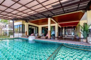 a swimming pool in a villa with a house at 6 Bedrooms Seaview With Pool - Belle Sunset Villa in Ko Lanta +48 photos
