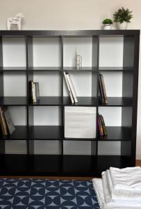 a black and white book shelf with books at MIALLEGRA Guest House in Bellona