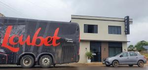 a black truck parked in front of a building at Hotel Serrano in Inácio Martins