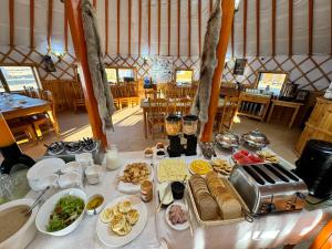 a table with food on it in a tent at Maikhan Tolgoi lodge in Horgo
