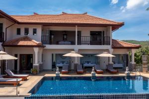 a villa with a swimming pool and a house at Amazing Seaview Villa Serena 4 Bedrooms in Ko Lanta +32 photos