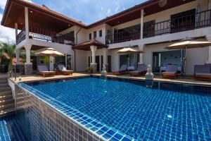 a swimming pool in front of a villa at Amazing Seaview Villa Serena 4 Bedrooms in Ko Lanta