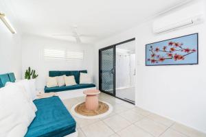 a living room with a couch and a table at The Springs Villa 2 in Urangan