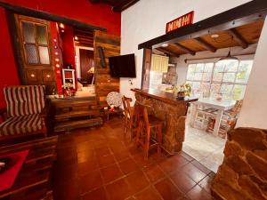 a living room with a bar and a table and chairs at Hospedaje San Luis Sierras in Juana Koslay 