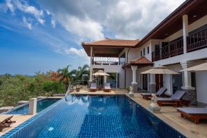 a swimming pool in front of a villa at 2 Pools And Seaview! Villa Serena 6Br, Klong Khong in Ko Lanta