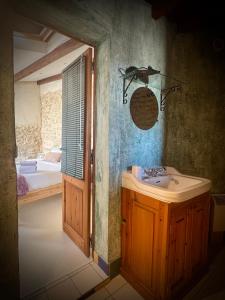 a bathroom with a sink and a bedroom at Extraordinaire face aux Arènes in Arles +95 photos