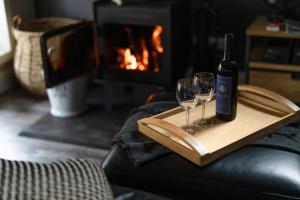 a bottle of wine and two wine glasses on a tray at The Duckling in Glenlyon +44 photos