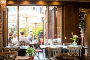 a restaurant with tables and people sitting at tables at Casa De' Fiori in Rome