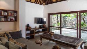 a living room with a couch and a table at Luxury Beachfront Villa in North Lombok in Gili Islands