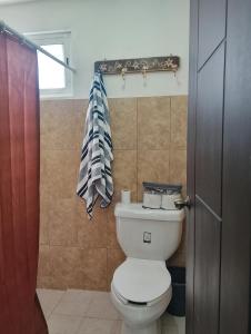 a bathroom with a toilet and a towel at Casa en la Palpa in Huauchinango +12 photos