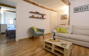 a living room with a couch and a table at 2 Bedroom Pet Friendly Apartment In Scansano in Scansano +13 photos