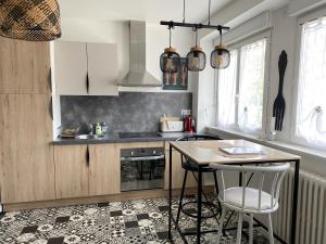 a kitchen with a counter and a table and chairs at Les Bruyeres in Concarneau
