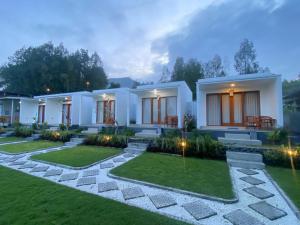 a bedroom villa with a garden at night at The Angga House in Bangli