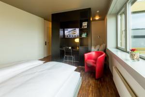 Ένα ή περισσότερα κρεβάτια σε δωμάτιο στο Dasbreitehotel am Rhein