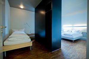 Ένα ή περισσότερα κρεβάτια σε δωμάτιο στο Dasbreitehotel am Rhein