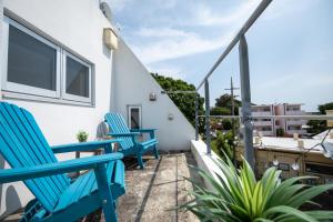 a pair of blue chairs on the balcony of a house at Balmy Ocean OKINAWA in Yomitan +64 photos