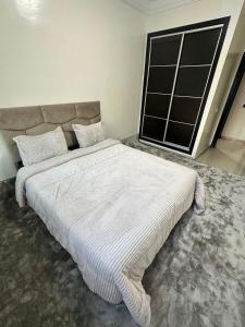 a large white bed in a room with a window at corniche d or piscine ferme le lundi in Mohammedia +16 photos
