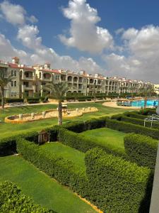 a view of a resort with a large building at Lasirena Palm Beach Sokhna Chalet in Ain Sokhna