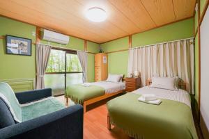 a small room with two beds and a couch at 一隅居 in Yaochō