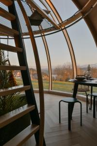 a room with a table and a chair and a window at AtmoSphere Czorsztyn in Czorsztyn