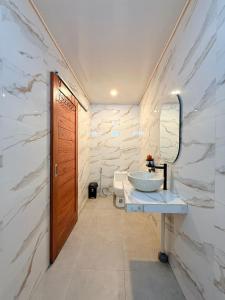 a bathroom with a sink and a mirror at The Angga House in Bangli