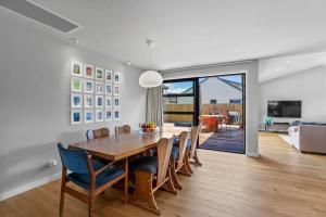 a dining room with a wooden table and chairs at Rua Street Escape in Wanaka