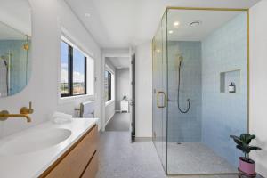 a bathroom with a glass shower and a sink at Rua Street Escape in Wanaka +17 photos