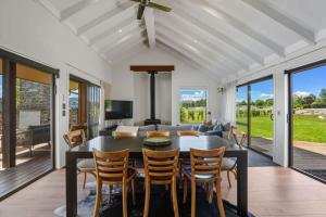 a dining room and living room with a table and chairs at Wanaka Mountain Oasis - Spa & Pool in Wanaka