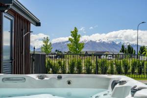 a bath tub with a view of mountains at Wanaka Mountain Oasis - Spa & Pool in Wanaka +17 photos