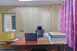 a table with a computer and a bottle on it at Super Collection O Gachibowli Phase 2 Formerly SK Stays in Gachibowli