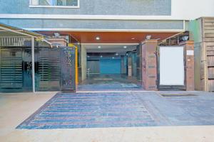 an empty hallway of a building with a white door at Super Collection O Gachibowli Phase 2 Formerly SK Stays in Gachibowli +38 photos