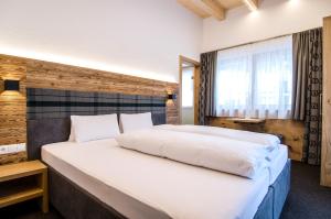 Posteľ alebo postele v izbe v ubytovaní Hotel Garni Persutt