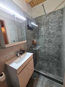 a bathroom with a sink and a shower at Οκά & δράμι in Kaléntzion +5 photos