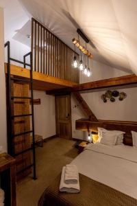 a bedroom with a large bed and a wooden staircase at Wanderer Sighisoara in Sighişoara +55 photos