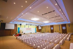 a large room with rows of chairs and a stage at Royal Nakhara Hotel and Convention Centre in Nong Khai