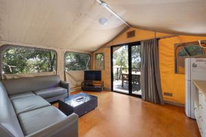 a living room with a couch and a table at Reflections Red Rock - Holiday Park in Red Rock