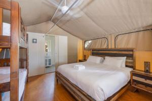 a bedroom with a large bed in a tent at Reflections Red Rock - Holiday Park in Red Rock