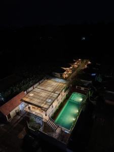 an overhead view of a swimming pool at night at Arnez Tropical Cottage in Pronojiwo +29 photos