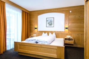 Posteľ alebo postele v izbe v ubytovaní Hotel Garni Persutt