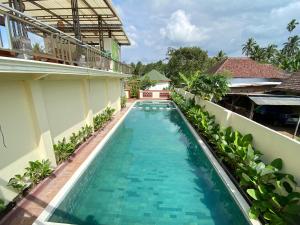a swimming pool in the middle of a building at Arnez Tropical Cottage in Pronojiwo