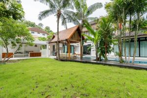 an image of a house with a yard at Chalong Thai-Style Pool Villa in Phuket