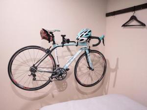 a bike is hanging on a wall at Guest House BLUE DOOR in Imabari Railway Station